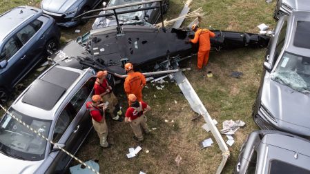 An aerial view shows firefighters working at the site of a helicopter crash in the Recreio dos Bandeirantes neighbourhood in Rio de Janeiro, Brazil, on June 14, 2026. At least six people died in Brazil on June 14 after two helicopters crashed in western Rio de Janeiro, after a suspected mid-air collision, firefighters said. (Photo by Tercio TEIXEIRA / AFP)